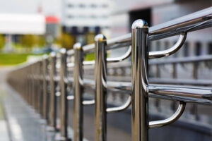 Chromium metal fence with handrail. Chrome-plated metal railings. Shallow depth of field. Selective focus.